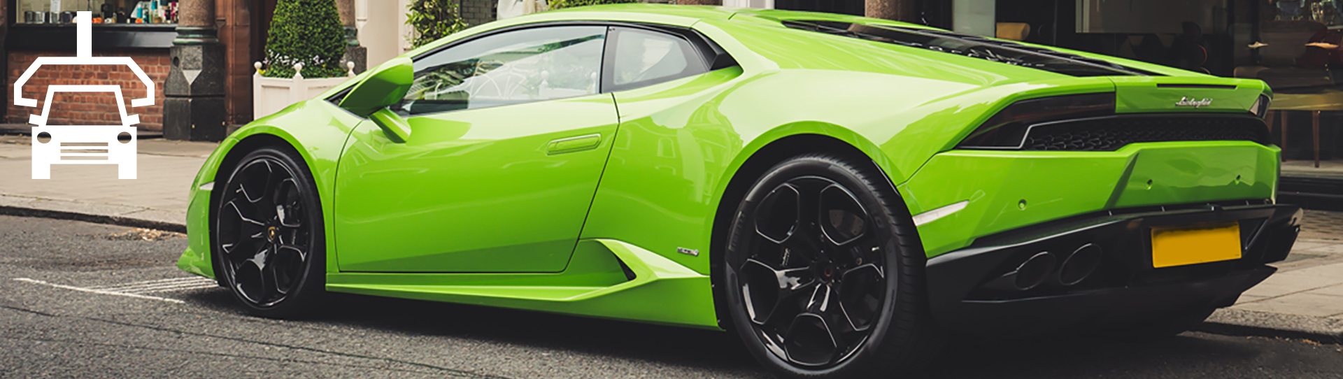 Automotive-hero_1920x542 A bright green sports car is parked on a city street beside a sidewalk. The car has black wheels and a yellow rear license plate. The Automotive icon is in the top left corner.