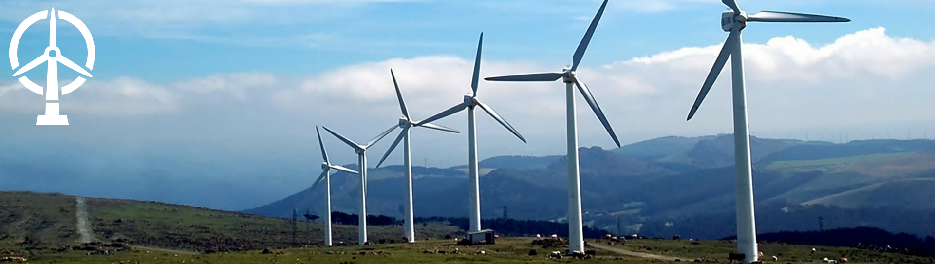 A row of wind turbines stands on a grassy hill with mountains in the background under a partly cloudy sky. A white wind energy icon appears in the top left corner.