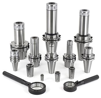SK Collet Chucks_350x341_96 dpi A collection of metal tool holders, collets, and spanner wrenches arranged upright and lying flat on a white background, showing various sizes and types of machining equipment.