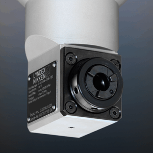 Close-up of an angle head with a recessed collet seat and a label reading LYNDEX NIKKEN and technical specifications on the side, set against a neutral background.