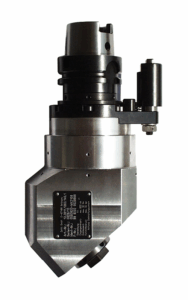 A Fixed Angle Head with a cylindrical top section and an angled rectangular base, featuring bolts, a black label with text, and a mounted cylindrical attachment on one side.
