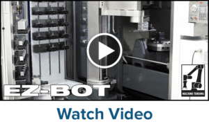 A robotic machine tending system labeled EZ-BOT is shown inside an industrial workspace. A play button icon suggests a video. The lower right corner displays a robot arm graphic with MACHINE TENDING. “Watch Video” text appears below.