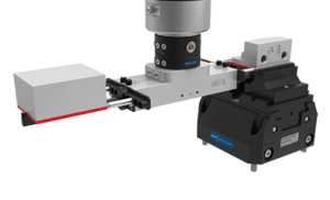 An EZ-COB gripper with a black base, metallic rails, and a motorized actuator, used for industrial automation. Various connectors and a Zero Clamp mount are visible.