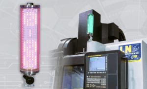 An EZ-SmartTower LED signal light is shown glowing red on the left. On the right, the EZ-SmartTower, glowing green, is mounted on top of an industrial machine with a control panel and display.