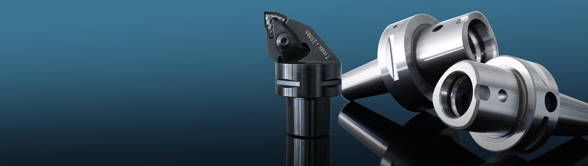 PSC-Hero_1920x542 Two PSC polygonal tool holders and one static tool are placed against a gradient blue background.