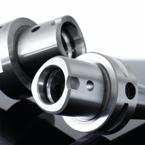 Two PSC Polygonal tool holders, positioned diagonally on a reflective black surface showing the polygonal taper.