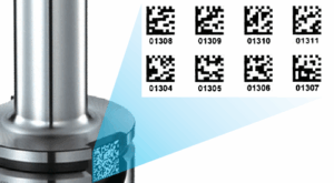 A close-up of a tool holder with a Data Matrix code on its surface. An enlarged view shows multiple Data Matrix codes labeled with numbers for tracking.