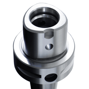Close-up of a shiny, cylindrical metal machine part with a rounded triangular top, circular openings, and machined grooves, likely used in mechanical or industrial applications.