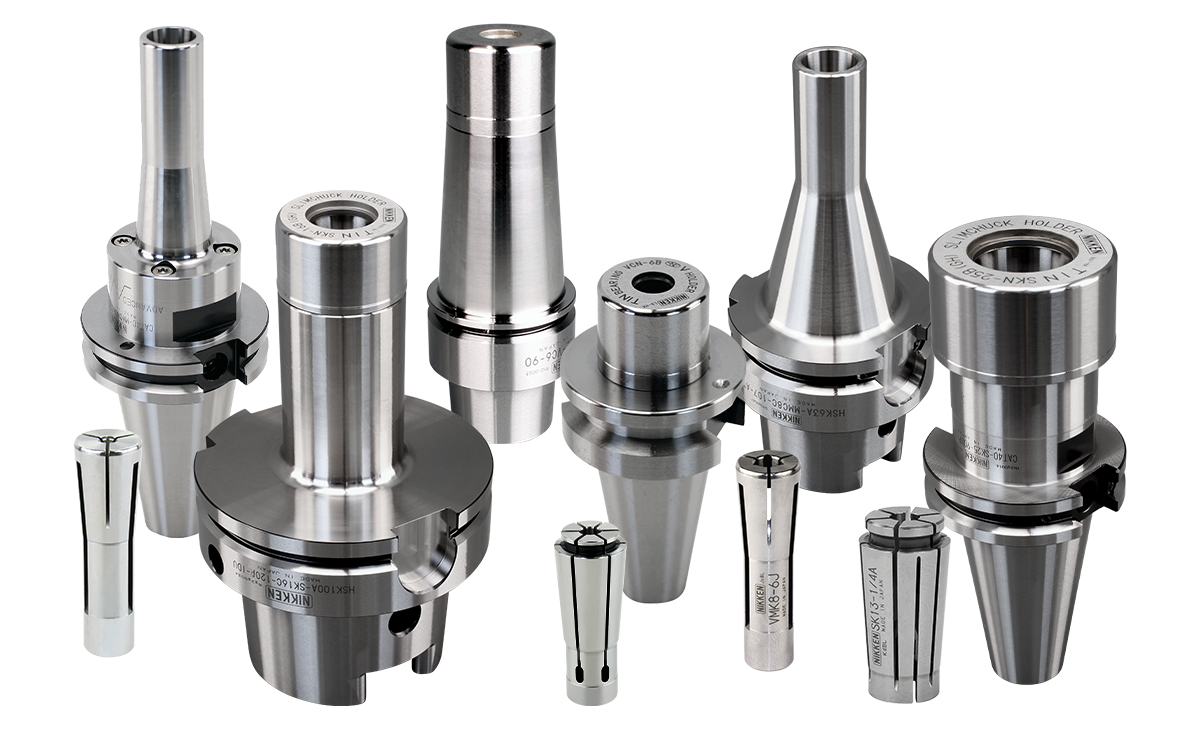 A group of metallic tool holders and collets of various sizes and shapes are arranged side by side on a white background. The surfaces are shiny and machined, with some engraved markings visible.