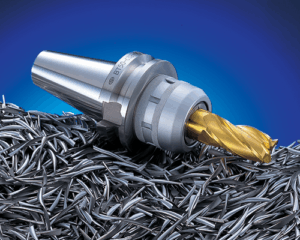 A gold-colored end mill cutting tool attached to a metal holder rests on a pile of metal shavings, with a gradient blue background.