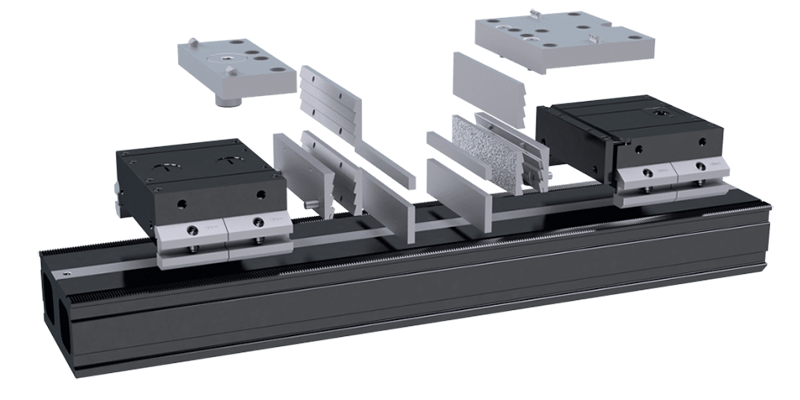 An exploded view of a linear guide assembly, including the rail, blocks, end caps, internal parts, and clamping system, all arranged in a separated manner for clarity.