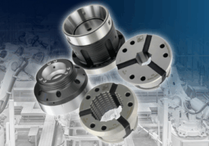 Four metal mechanical components, including chucks, couplings, and a quick change flex collet, are arranged on top of a faded background showing an automated industrial production line with robotic arms and conveyor belts.