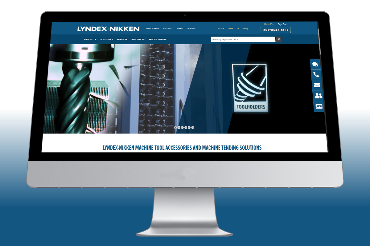 Lyndex-Nikken-New-Website-on-Monitor_1200x800 A computer monitor displays the Lyndex-Nikken website homepage, featuring navigation menus, product images of machine tool accessories, and a toolholders icon. The background fades from blue at the bottom to white at the top.