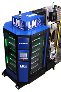Product-Manuals-Machine-Tending_200x300 A Lyndex-Nikken EZ-TEND system with a touch screen interface, vertical glass panels showing internal shelves, and indicator lights, positioned next to other factory equipment.
