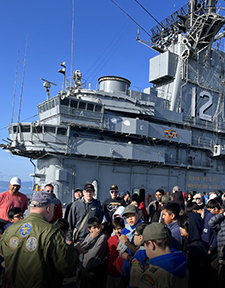 Group of attendees on the deck of the USS Hornet.