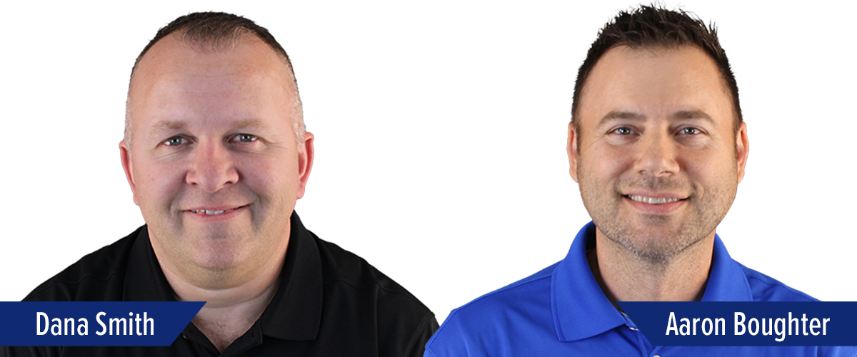 Three men are posed side by side, all facing the camera and smiling. They each wear collared shirts with company logos. Name tags read Chris Dones, Dana Smith, and Aaron Boughter.